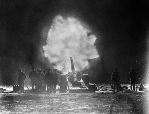 A naval gun firing over Vimy Ridge behind Canadian lines at night on the Western Front in northern France during the First World War. Date: May 1917