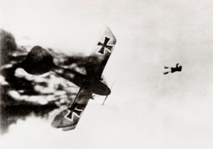 German pilot jumping from his burning Albatross aeroplane after it was shot down over enemy lines during World War One. Photograph from a series on aerial combat, the majority of the photographs were taken by a British pilot. The pilot recounted the fight that led to this picture: 'A Hun went down under control and Jock (fellow pilot) nosed after it to get it. Then saw it on fire and followed it down, watching pilot struggle to bring it all the way down. Heat must have been terrific. Noticed pilot trying to jump out...Camera caught him just as he left the burning plane.'